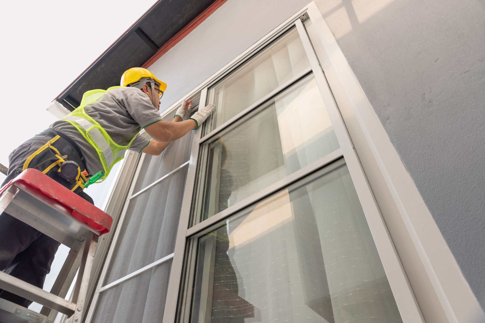 man fixing outside window